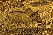 Luang Prabang, Laos - Wat Mai the gilded stucco engravings of the veranda. They narrate the Vessantara Jataka with various animals engraved at the base of the relief.